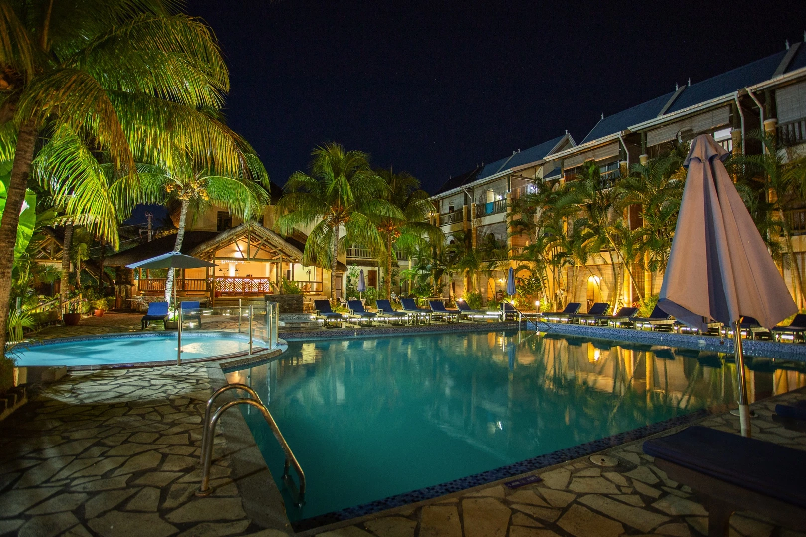 Le Palmiste Resort & Spa illuminated swimming pool at night in Mauritius