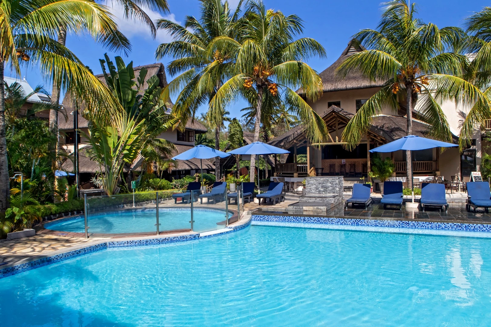 Le Palmiste Resort & Spa swimming pool surrounded by palm trees in Trou aux Biches Mauritius