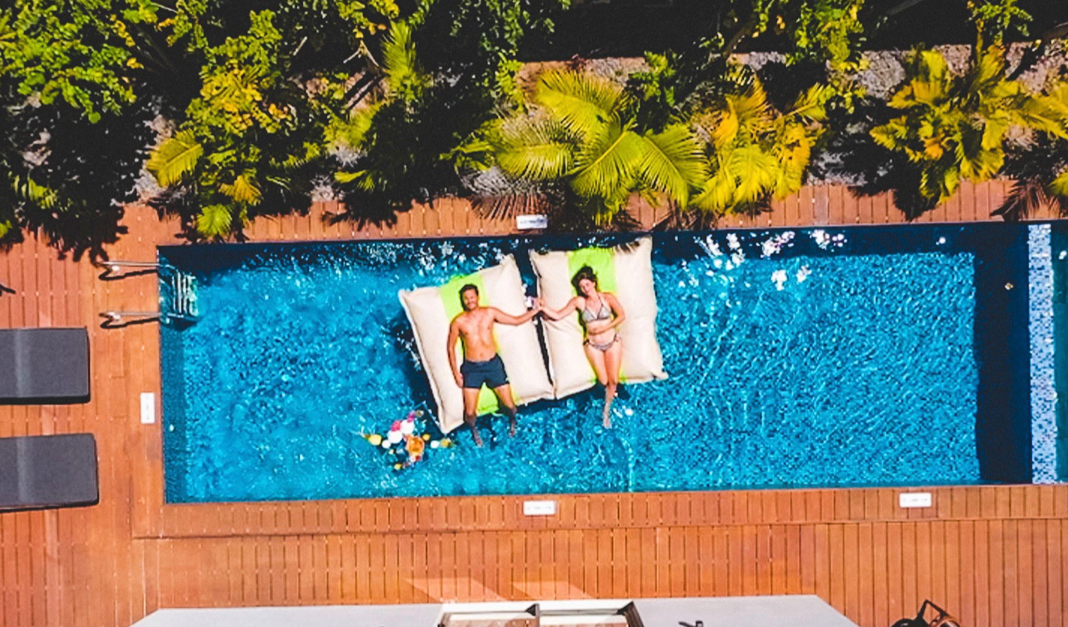 Aerial view of the Deluxe Villa at Wonders Beach with private pool, two adults relaxing on the pool